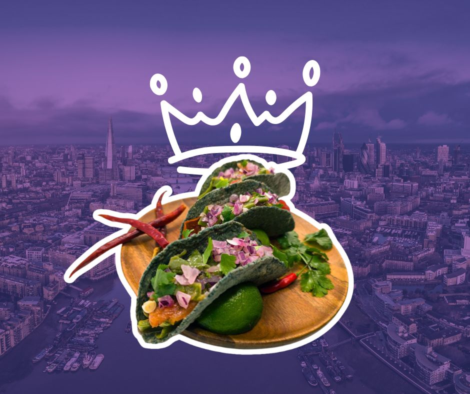 Blue corn tacos on a wooden plate with chillies and limes over a London skyline background representing tacos London at Proper Tacos